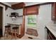 Vintage kitchen featuring a breakfast bar, window with sunlight, and classic wood accents at 1507 N Luett Ave, Indianapolis, IN 46222