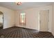 Spacious living area featuring neutral walls, textured carpet and a front door at 1507 N Luett Ave, Indianapolis, IN 46222