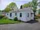 View of the home's exterior and backyard with ample parking on a paved driveway at 1507 N Luett Ave, Indianapolis, IN 46222