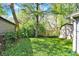 Spacious backyard with a mix of open lawn space and mature trees provides shade at 1523 E Perry St, Indianapolis, IN 46227