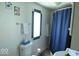 Cozy bathroom with patterned tile mirror, towels and shower at 1523 E Perry St, Indianapolis, IN 46227