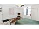 This bedroom features a ceiling fan and a window with a pleasant view, creating a comfortable and inviting atmosphere at 1523 E Perry St, Indianapolis, IN 46227