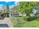 Charming single-story home with driveway, fenced-in yard, and quaint sunroom at 1523 E Perry St, Indianapolis, IN 46227