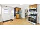 Efficient kitchen with wood floors, stainless appliances, and good storage solutions at 1523 E Perry St, Indianapolis, IN 46227