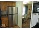 Well-lit kitchen featuring stainless steel refrigerator and wooden cabinets at 1523 E Perry St, Indianapolis, IN 46227
