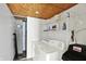 Well-lit laundry room with washer, dryer, and overhead shelving for storage and organization at 1523 E Perry St, Indianapolis, IN 46227