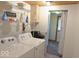 Functional laundry room with washer, dryer, and storage racks for cleaning supplies at 1523 E Perry St, Indianapolis, IN 46227