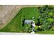Aerial view of charming home with expansive fenced backyard, lush greenery, outbuilding, and private driveway at 1683 W County Road 300 S, Danville, IN 46122