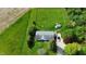 Aerial view of charming home with expansive fenced backyard, lush greenery, outbuilding, and private driveway at 1683 W County Road 300 S, Danville, IN 46122