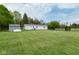 Sprawling backyard shows the home's back exterior and spacious lawn with fence perimeter at 1683 W County Road 300 S, Danville, IN 46122