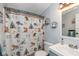 bathroom featuring an animal-themed shower curtain, unique shelving, and neutral color palette at 1683 W County Road 300 S, Danville, IN 46122