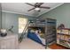 Charming bedroom featuring a wooden bunk bed, ceiling fan and a window bringing in natural light at 1683 W County Road 300 S, Danville, IN 46122