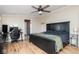 Comfortable bedroom features a ceiling fan, wood-look flooring, a large bed, and a gaming setup at 1683 W County Road 300 S, Danville, IN 46122