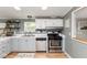 Functional kitchen with white upper cabinets, stainless steel appliances, and a breakfast bar at 1683 W County Road 300 S, Danville, IN 46122