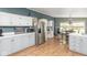 Open concept kitchen with stainless steel fridge, dining area, and modern cabinetry at 1683 W County Road 300 S, Danville, IN 46122