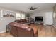 The living room features wood-look flooring, cozy leather seating, a ceiling fan, and natural light at 1683 W County Road 300 S, Danville, IN 46122
