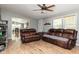 Comfortable living room with wood-look floors, plush sofas, and a glimpse of the adjoining dining area at 1683 W County Road 300 S, Danville, IN 46122