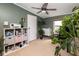 Bright office space with neutral carpet and green walls and a full storage and shelving unit at 1683 W County Road 300 S, Danville, IN 46122