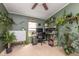 Bright home office space with neutral carpet, green walls, and shelving full of plants at 1683 W County Road 300 S, Danville, IN 46122