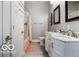Elegant bathroom featuring double vanity with marble countertops and modern fixtures, next to a full tub at 1808 E 11Th St, Indianapolis, IN 46201