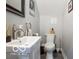 Modern half bath with a white sink, a comfort height toilet, and contemporary fixtures at 1808 E 11Th St, Indianapolis, IN 46201