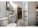 Beautiful bathroom with double sinks, framed mirrors, a shower, and a walk-in closet at 1808 E 11Th St, Indianapolis, IN 46201