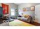 Cozy bedroom with a comfortable sofa and a Champions banner, decorated with framed art and modern lighting at 1808 E 11Th St, Indianapolis, IN 46201
