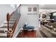 Home entryway with wooden floors, bench seating, and staircase leading upstairs at 1808 E 11Th St, Indianapolis, IN 46201