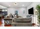 Spacious living room with gray walls, wooden floors, and plenty of seating at 1808 E 11Th St, Indianapolis, IN 46201