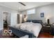 Spacious main bedroom with hardwood floors, neutral paint, ceiling fan, and ample natural light at 1808 E 11Th St, Indianapolis, IN 46201