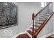 Staircase with wood railings and a striking map decor at 1808 E 11Th St, Indianapolis, IN 46201
