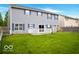 Backyard features a spacious lawn, home with siding and blue shutters at 1831 Brook Crossing Way, Indianapolis, IN 46229