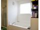 Bright bathroom with a soaking tub and a separate shower, plus a small shelf next to the window at 1831 Brook Crossing Way, Indianapolis, IN 46229