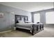 Spacious bedroom features neutral walls, carpet, and a large bed with natural light from two windows at 1831 Brook Crossing Way, Indianapolis, IN 46229