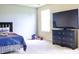 Bedroom featuring a black dresser, a TV and a vibrant blue and purple bed with a single window at 1831 Brook Crossing Way, Indianapolis, IN 46229