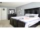 This bedroom boasts a large bed, a dresser, carpeted floors, and a calm, gray color scheme at 1831 Brook Crossing Way, Indianapolis, IN 46229