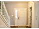 Bright entryway boasts wood floors, a white front door with glass insert, and white trim at 1831 Brook Crossing Way, Indianapolis, IN 46229