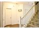 Hallway features stairs, white trim, wood floors, and doors leading to other rooms at 1831 Brook Crossing Way, Indianapolis, IN 46229