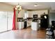 Bright kitchen with white cabinetry, an island, stainless steel appliances and dark countertops at 1831 Brook Crossing Way, Indianapolis, IN 46229