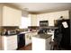Functional kitchen with white cabinets, black appliances, tile backsplash, and island at 1831 Brook Crossing Way, Indianapolis, IN 46229