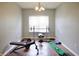 Workout room featuring hardwood floors, neutral walls, weight rack and weight bench at 1831 Brook Crossing Way, Indianapolis, IN 46229
