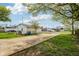 Back of the detached garage with a concrete parking area and green grass at 202 Mckim Ave, Indianapolis, IN 46201