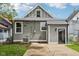 Back of the home with gray siding, large yard and new windows at 202 Mckim Ave, Indianapolis, IN 46201