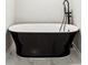 Freestanding white bathtub with black fixtures and marble flooring at 202 Mckim Ave, Indianapolis, IN 46201