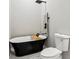 Bathroom features a modern black tub with matte black fixtures, and a toilet at 202 Mckim Ave, Indianapolis, IN 46201