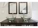 Bathroom featuring double vessel sinks, a dark vanity, mirrors, and gray walls at 202 Mckim Ave, Indianapolis, IN 46201