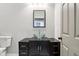 Bathroom with a dark vanity, modern glass bowl sink, gray walls, and a mirror at 202 Mckim Ave, Indianapolis, IN 46201