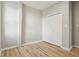 Bedroom with light-brown hardwood floors, light-gray walls, white trim, and a closet at 202 Mckim Ave, Indianapolis, IN 46201