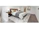 Bedroom with bed and side tables on a carpeted floor with a geometrically patterned rug at 202 Mckim Ave, Indianapolis, IN 46201