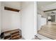 Entryway featuring a wooden shoe rack and coat rack, leading to a modern kitchen at 202 Mckim Ave, Indianapolis, IN 46201